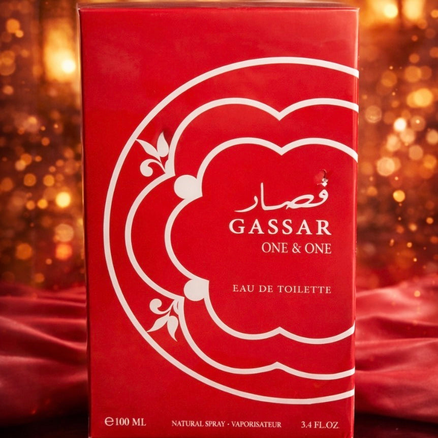 Red GASSAR One & One Eau de Toilette packaging with a blurred golden background