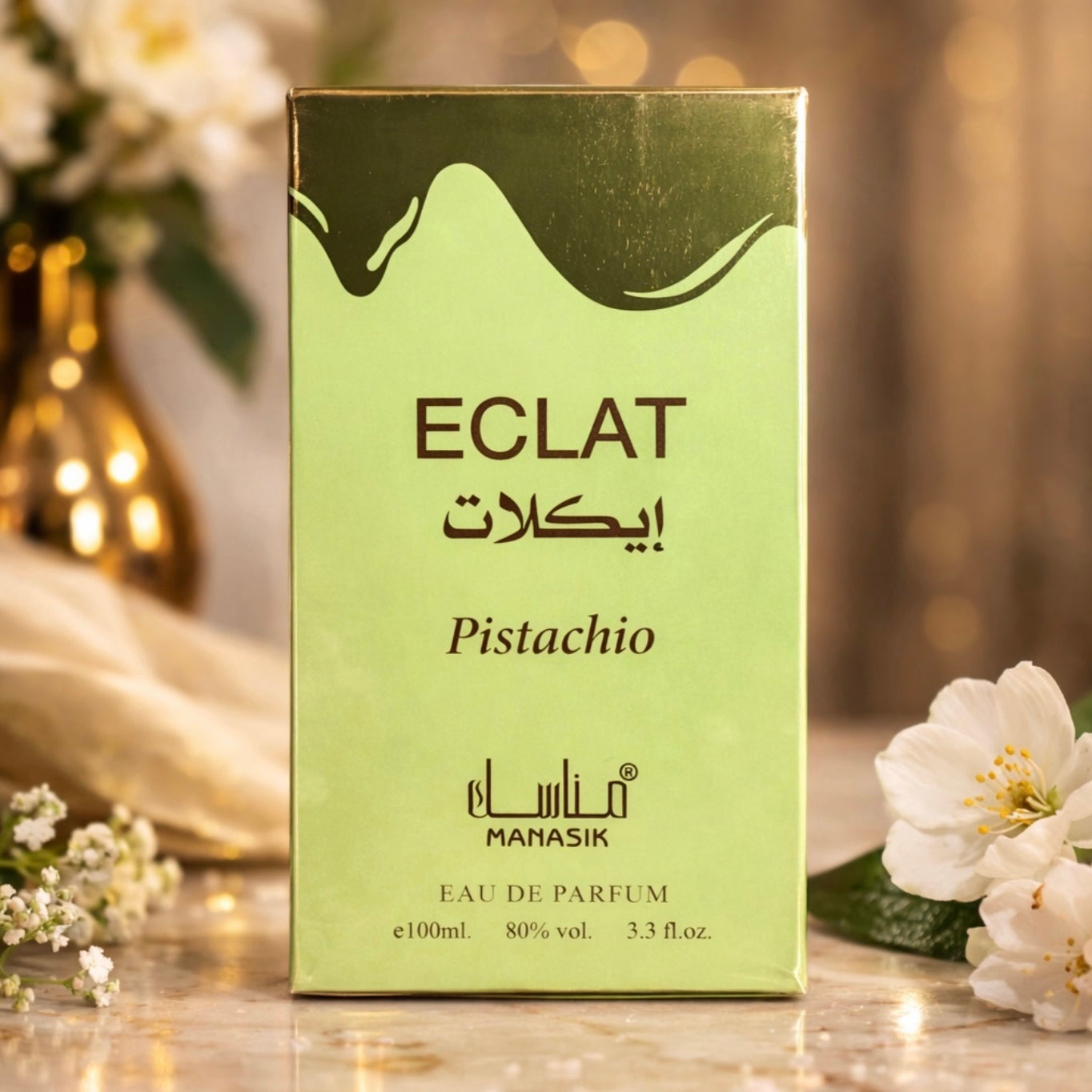 Green ECLAT Pistachio perfume box with flowers in the background
