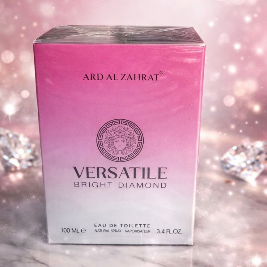Pink box of Ard Al Zahrat Versatile Bright Diamond perfume on a sparkling background