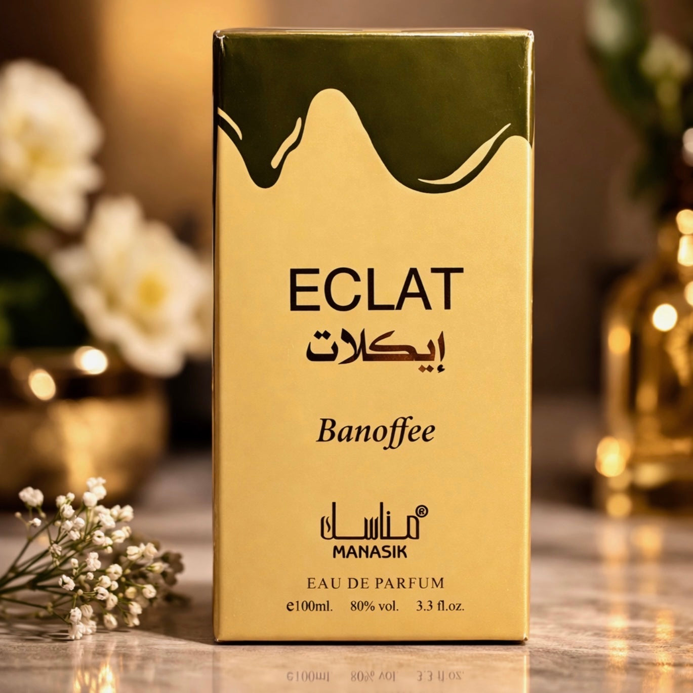Gold ECLAT Banoffee perfume box with floral and decorative background