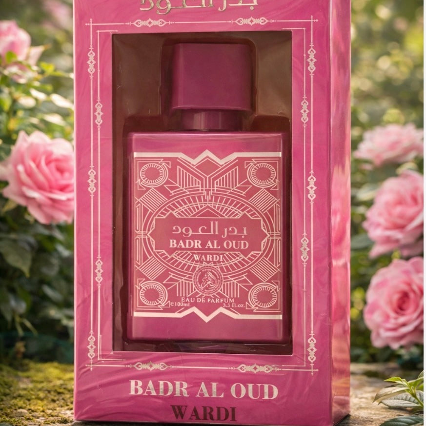 Badr Al Oud perfume bottle in pink packaging with roses in the background